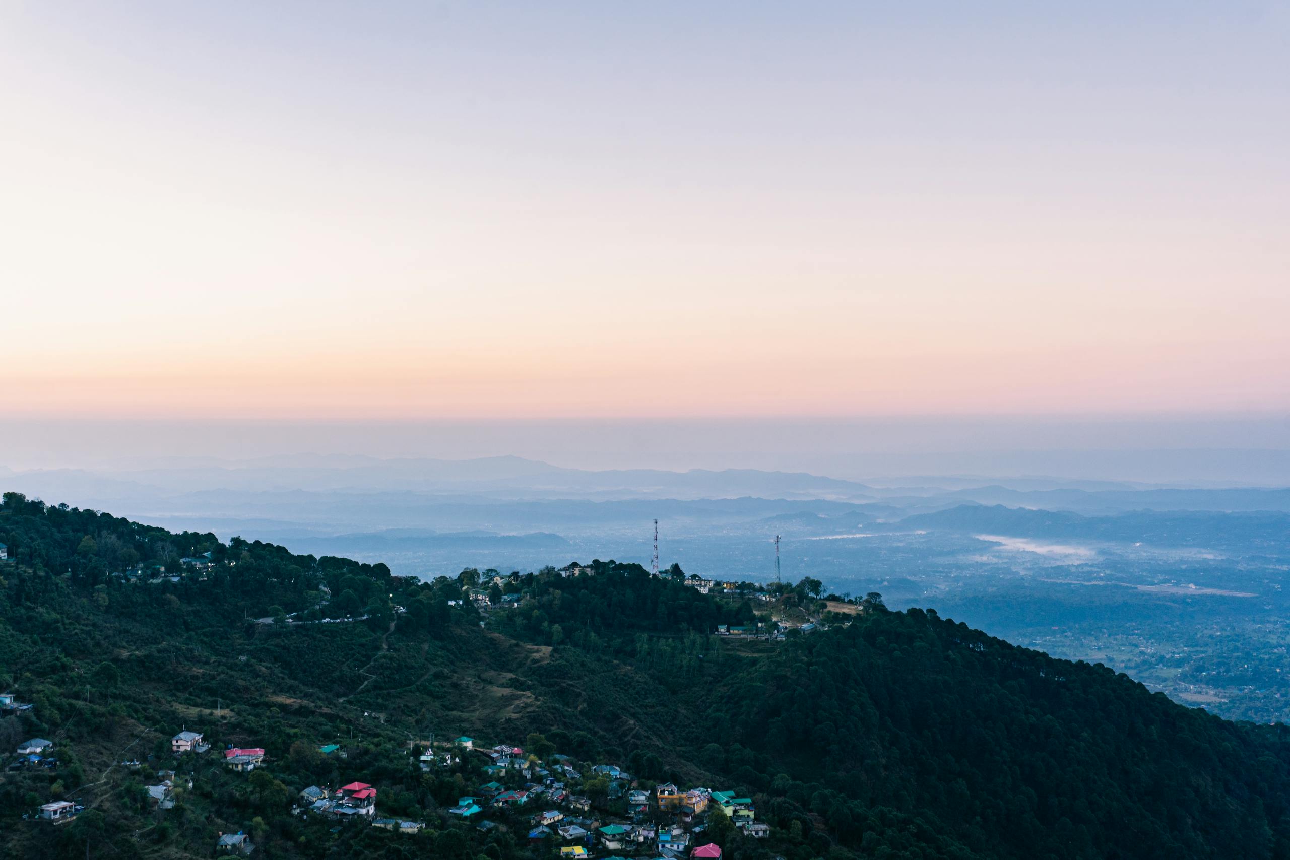 Breathtaking aerial view of Dalhousie hills at sunset with a vibrant sky.
